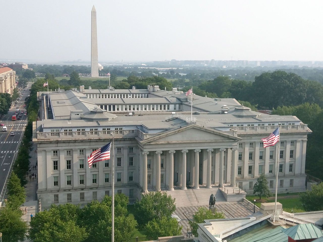 The US Treasury building with the Washington Monument behind it