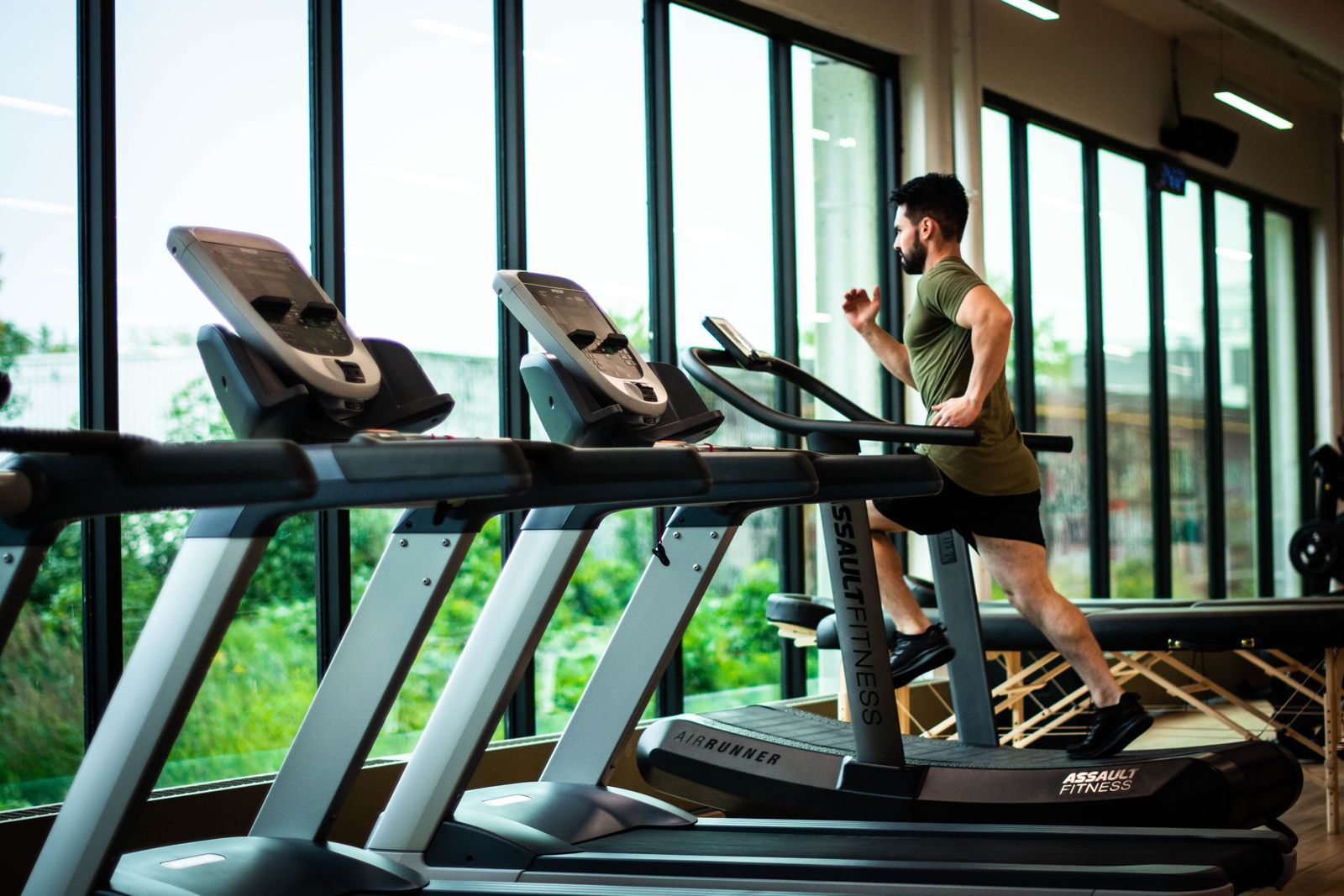 Treadmills by floor-to-ceiling windows in a fitness center