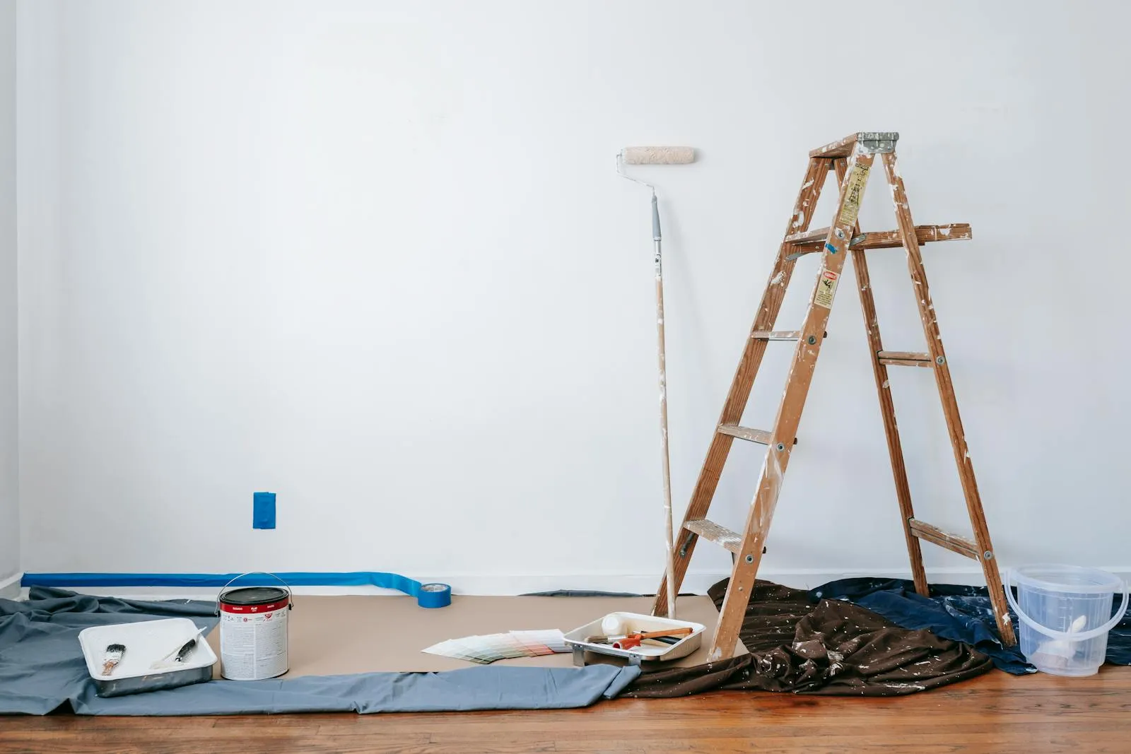 Post-construction cleanup with ladder and painting supplies