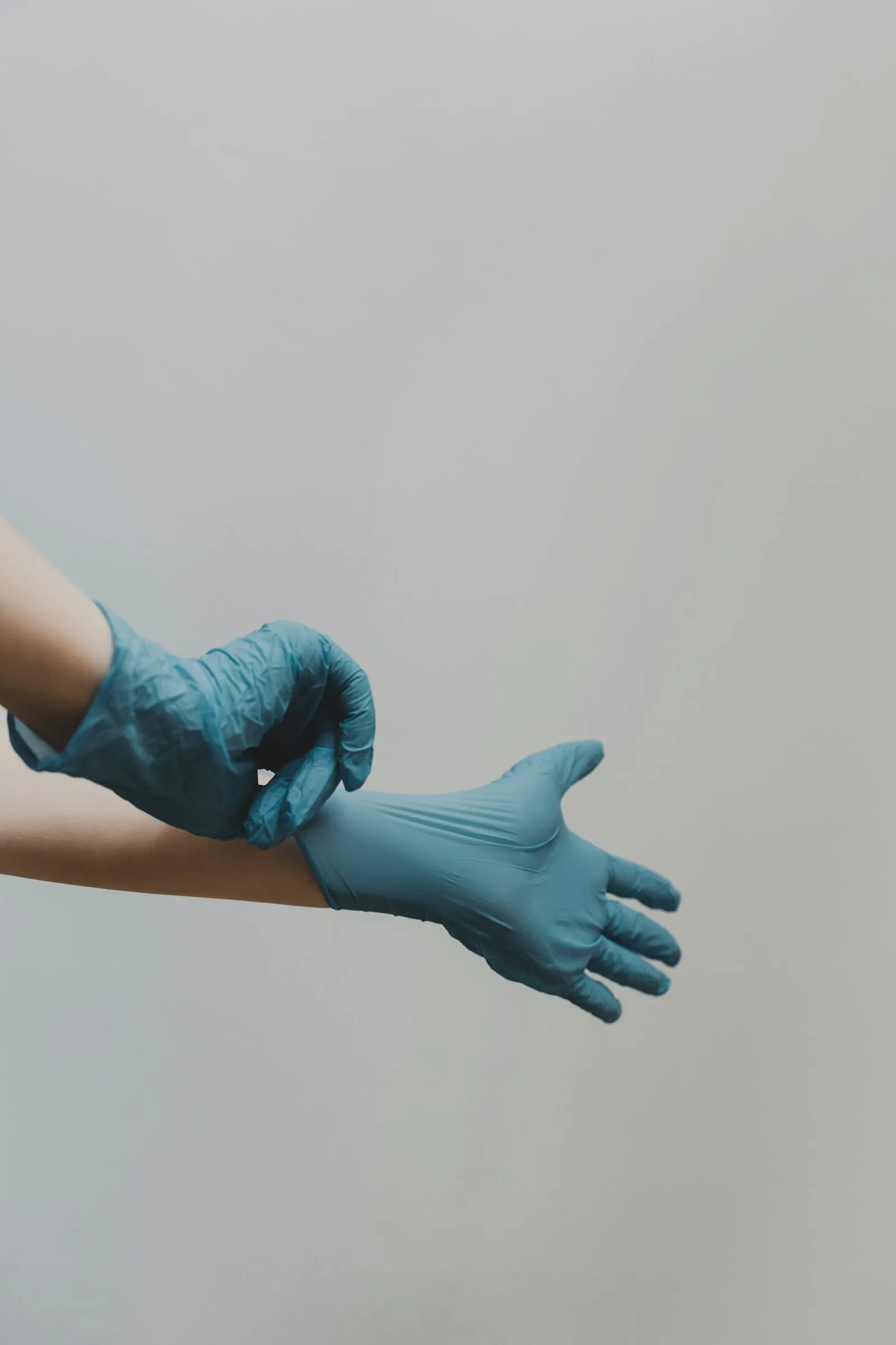 Pulling on professional nitrile gloves before a cleaning shift