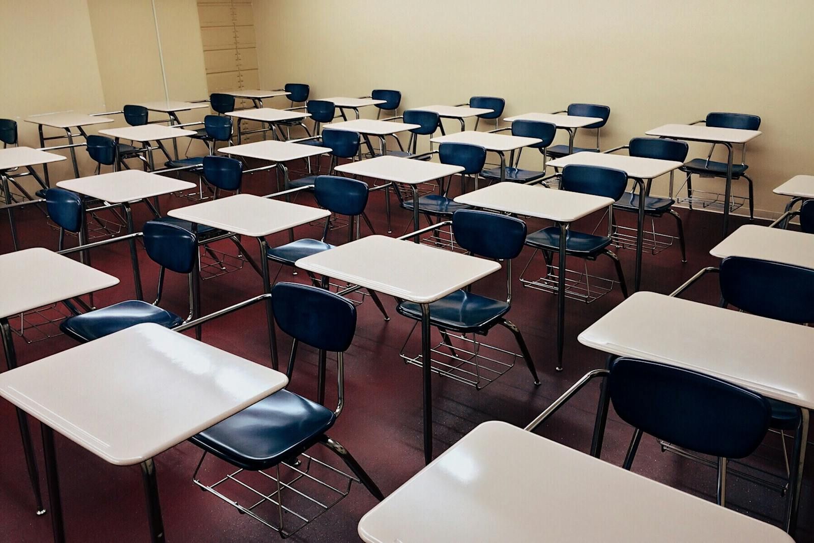Clean, empty classroom with desks in neat rows
